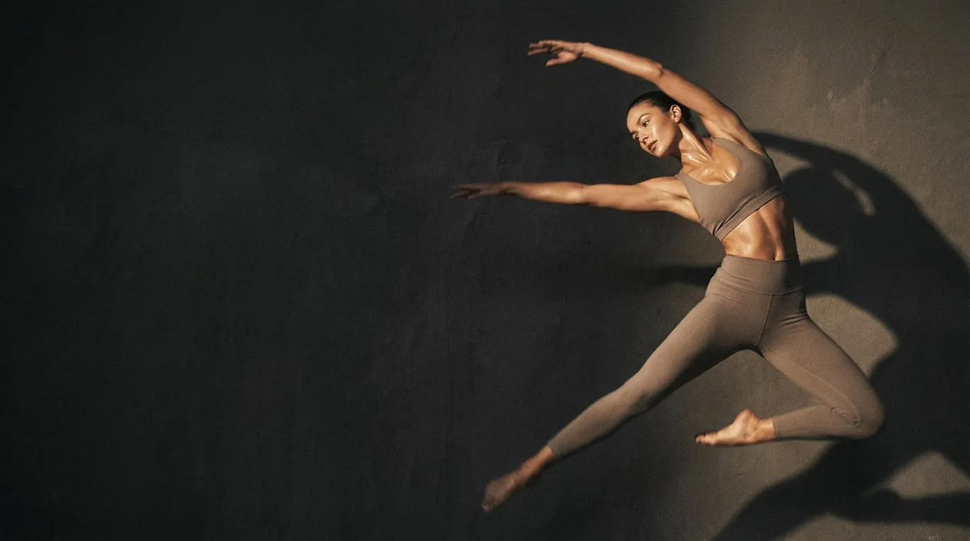 Dynamic Pilates movement in a dark studio
